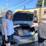 Wendy Donnell with car trunk open, showing sandwich delivery